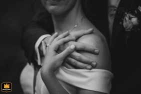 The couple stands close at Tenuta Bichi Borghesi in Tuscany, hands resting gently on the bride's shoulder in this touching black and white portrait emphasizing their intimate connection.